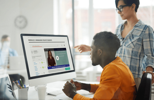 Two adults looking at a monitor