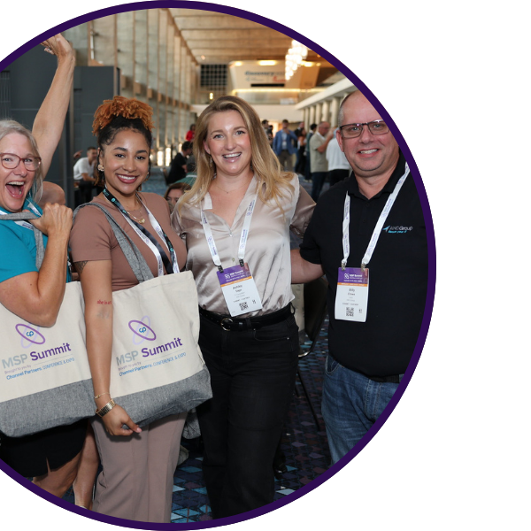 MSP Summit attendees excitedly posing for camera with badges and show bags