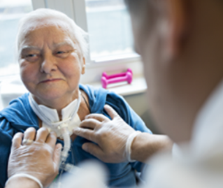 woman receiving trach tube