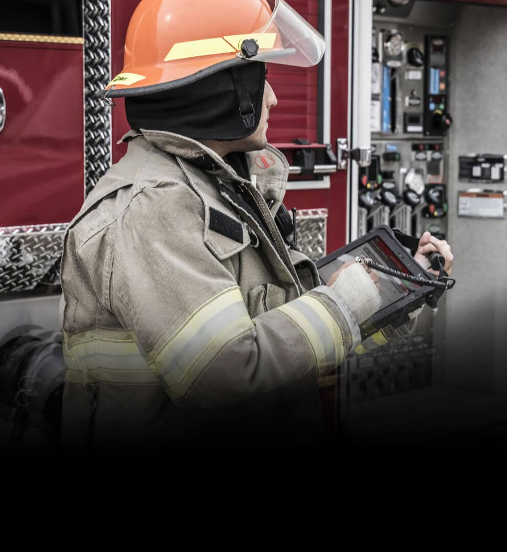 Firefighter sitting down looking at tablet