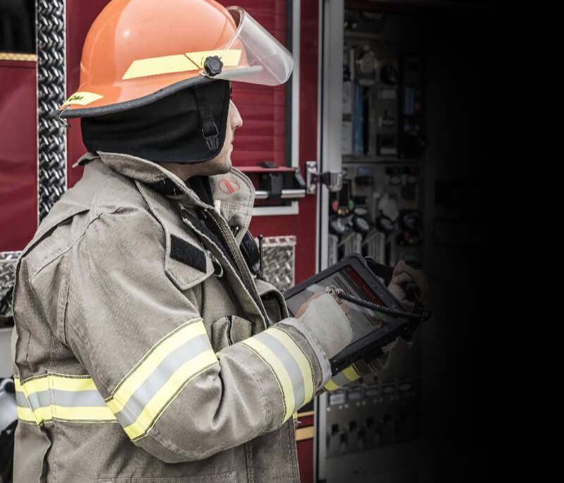 Firefighter sitting down looking at tablet